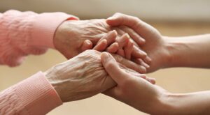 holding-hands-two-females-white-wearing-peach