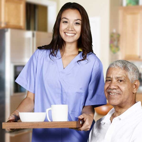 young-pretty-female-caregiver-serving-food-to-elderly-black-male-vert